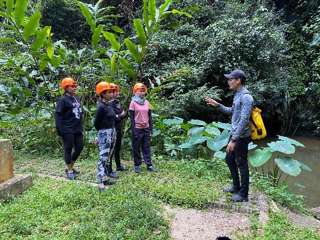 A group of people standing in a garden

Description automatically generated with medium confidence