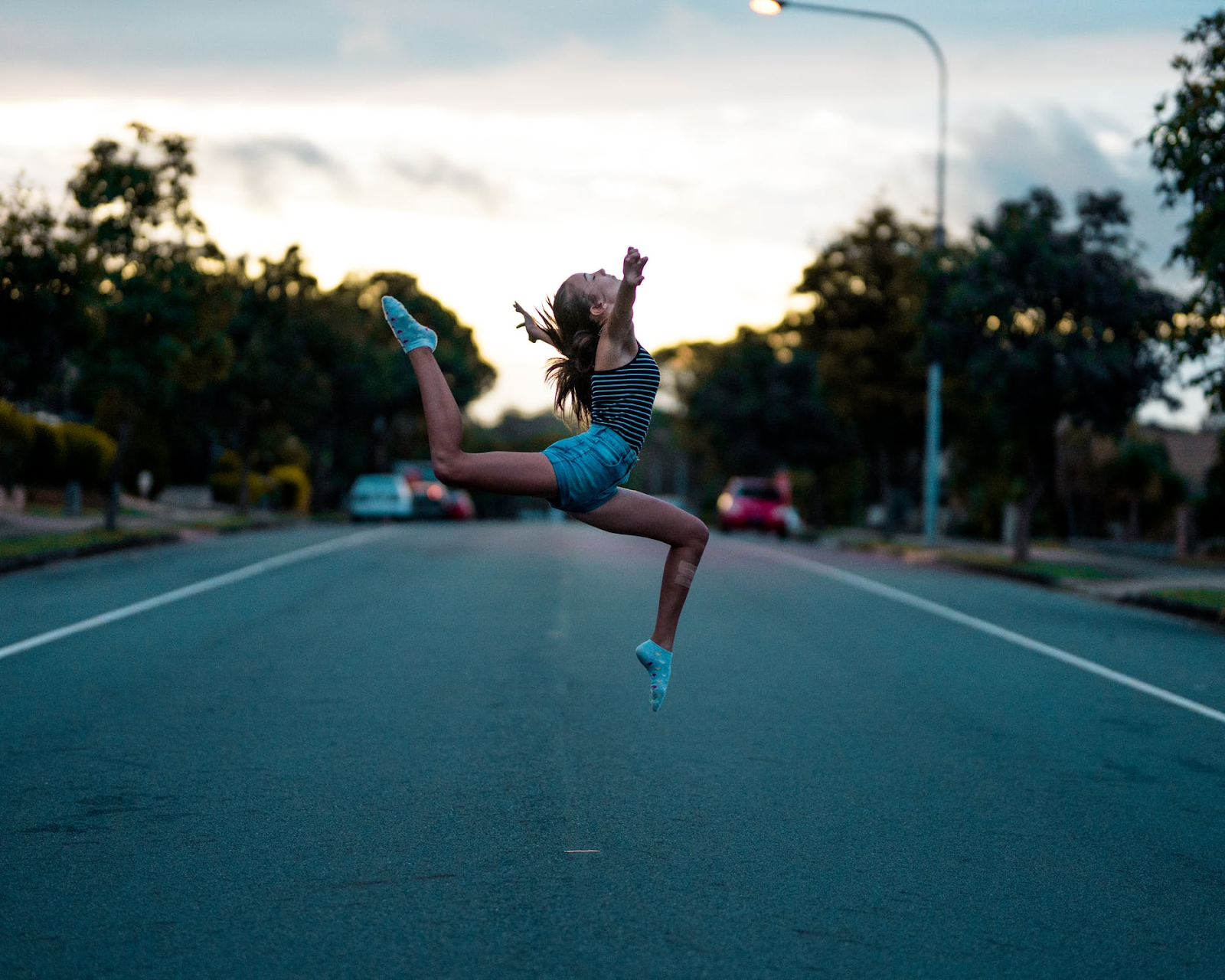 girl jumping in the middle of the street