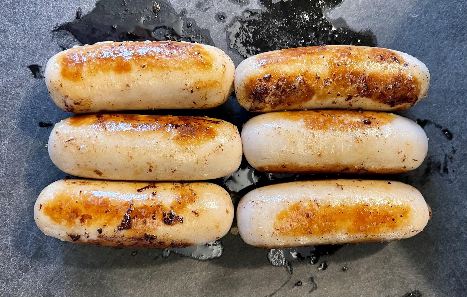 Photo of sausages cooked on a pan