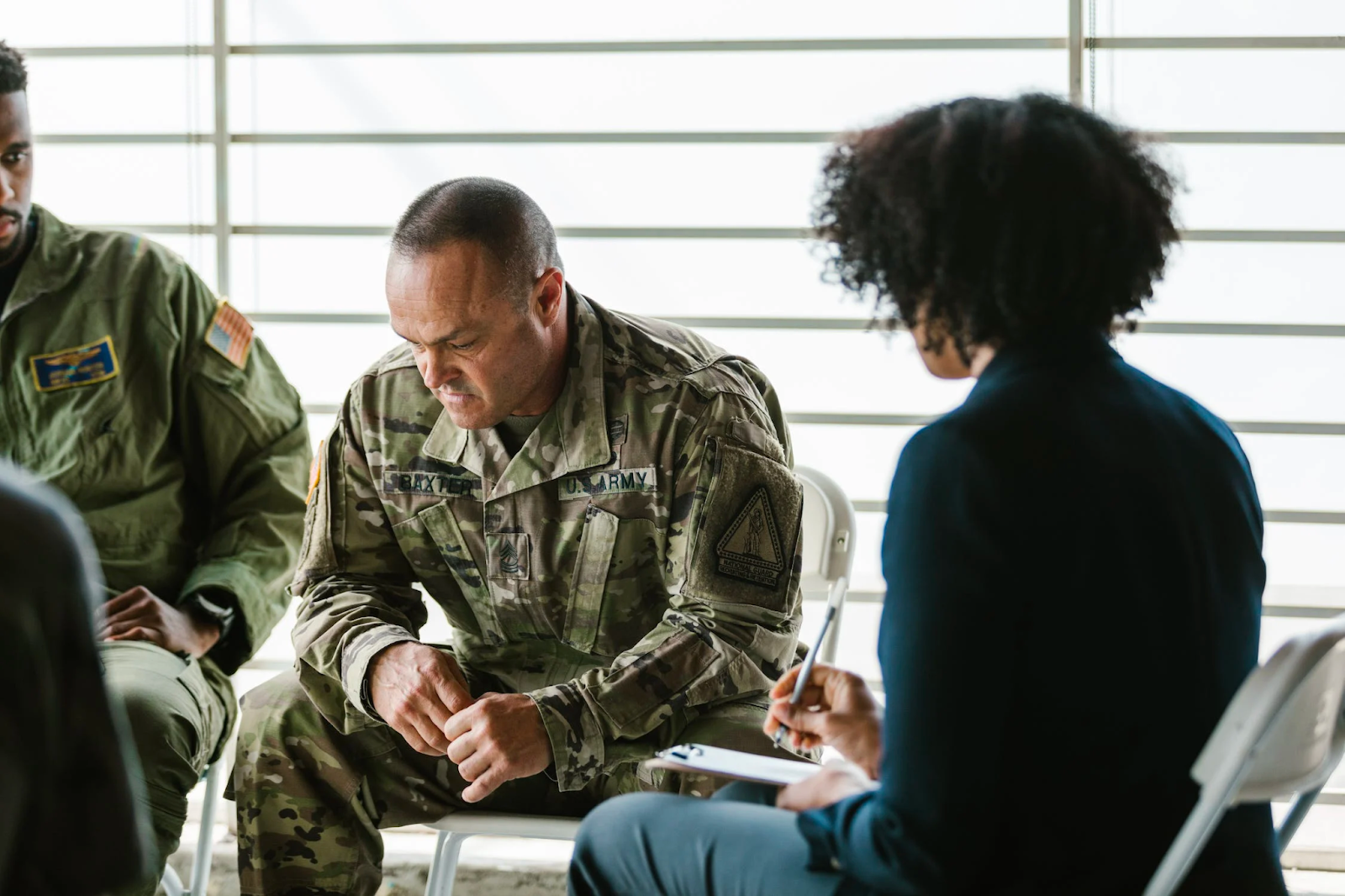 a soldier sitting down in a counseling meeting