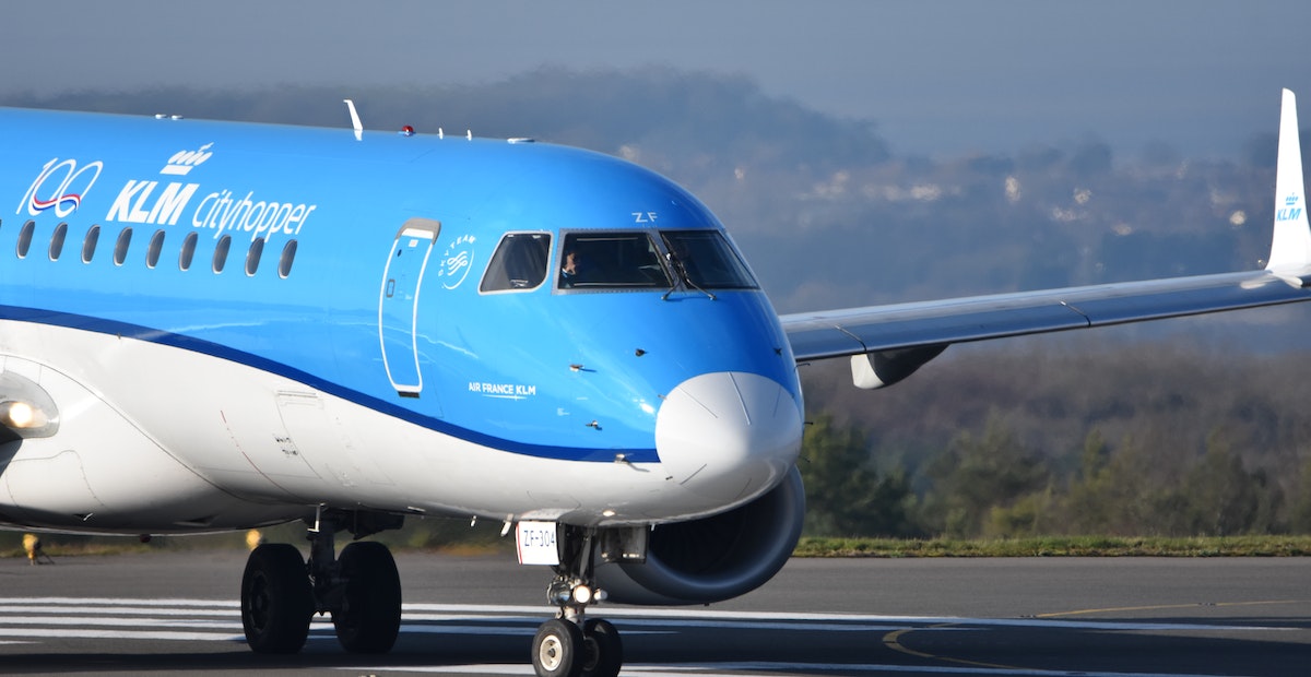 whatsapp marketing | Blue and white KLM plane on the runway. 