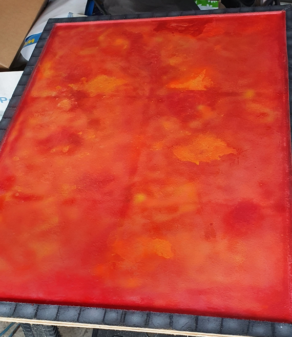 Initial lava paint job - a red based board with patches of brighter oranges and yellows