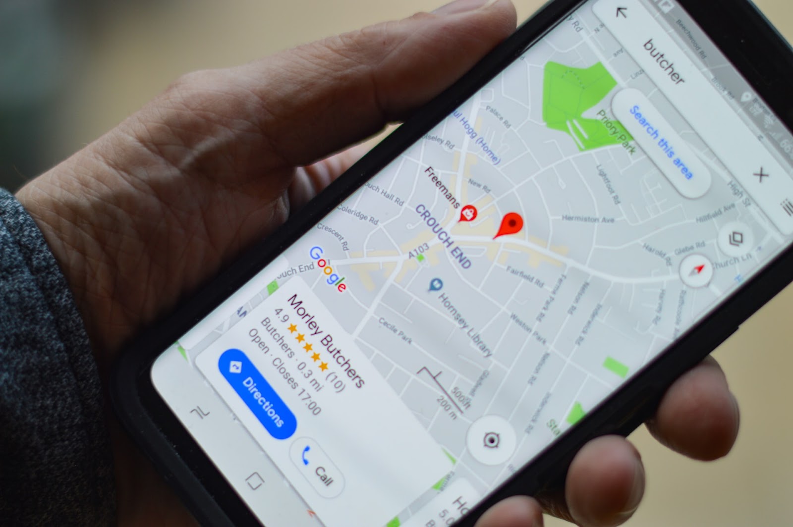 smartphone with google maps and google my business showing