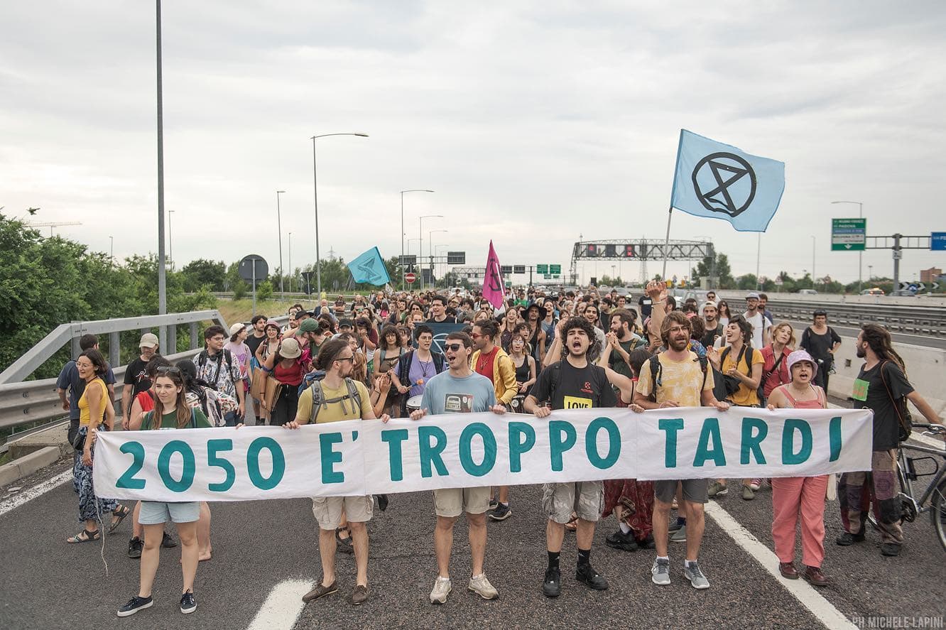 A crowd of young rebels march down a motorway