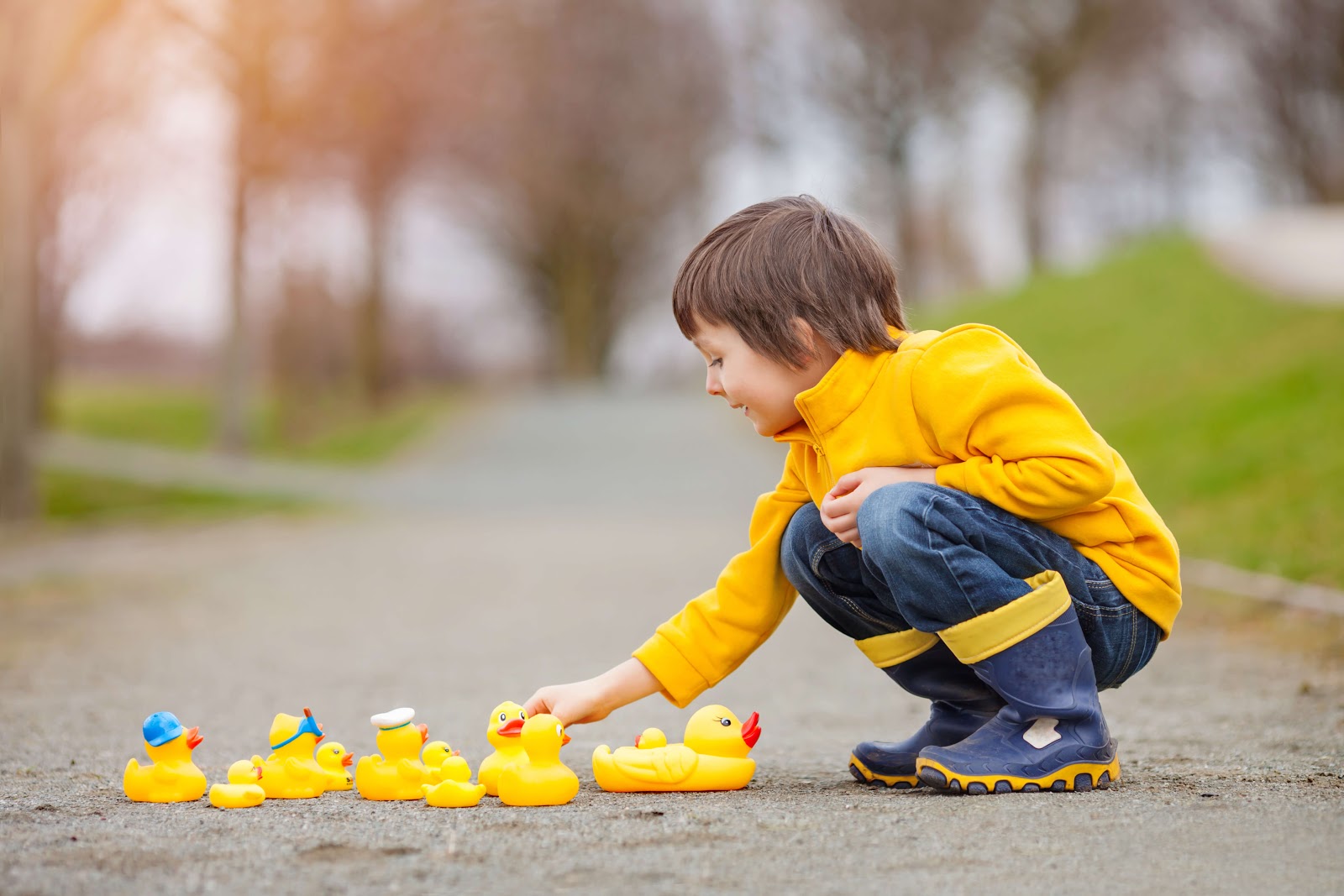 Child practicing debugging code with rubber ducks