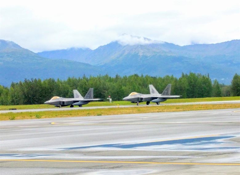 Two F-22 Raptors prepare to take off during an Air Force Operational Energy mission at Joint Base Elmendorf-Richardson in Anchorage, Alaska, Aug. 13, 2017. The aircraft were part of a demonstration to assess if flying at an increased speed consumes less fuel while saving precious flight hours. (U.S. Air Force photo by Corrie Poland)