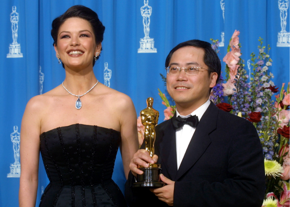 Tim Yip holds his Oscar.