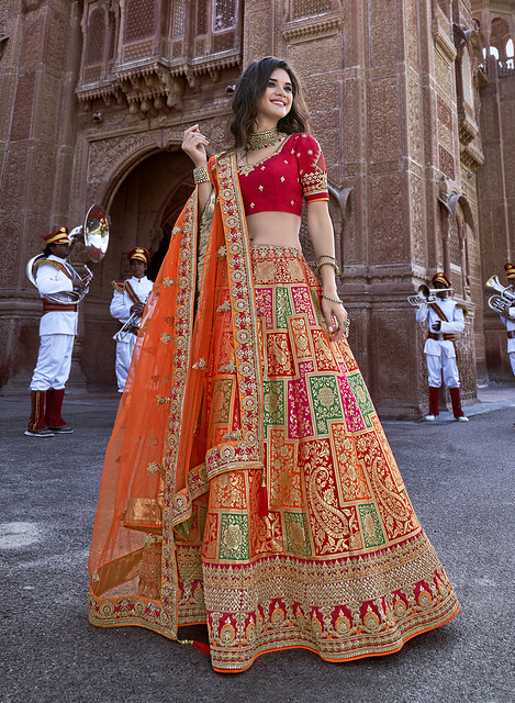 Orange lehenga with red blouse as a pop of color.