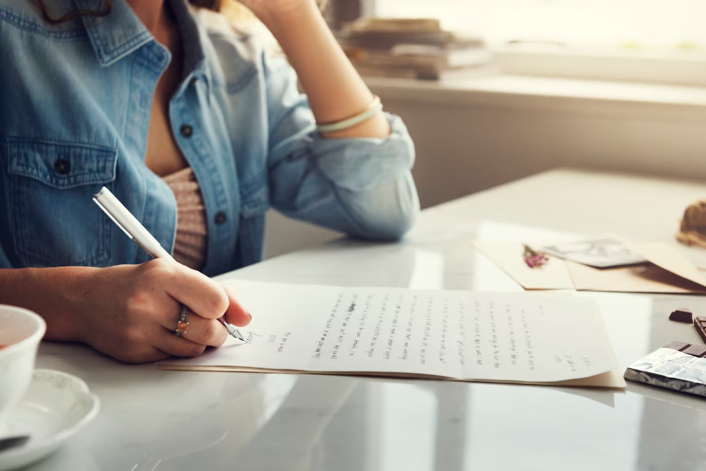 A person writing a letter