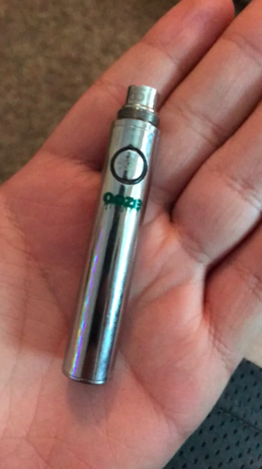 Image of someone holding an ooze weed vaporizer pen battery in their palm