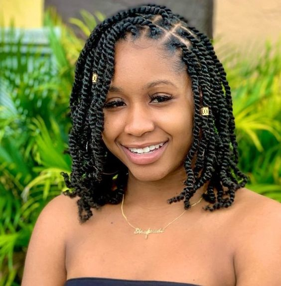 a lady wearing two-strand twists with hair cuffs