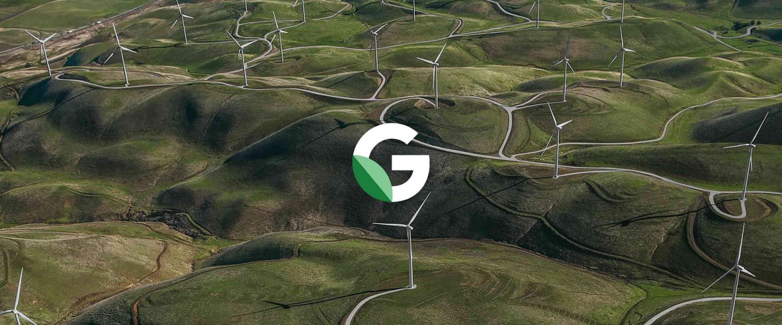 Image 1: 一片廣闊的綠色山丘上佈滿了風力發電機，中央有 Google 標誌