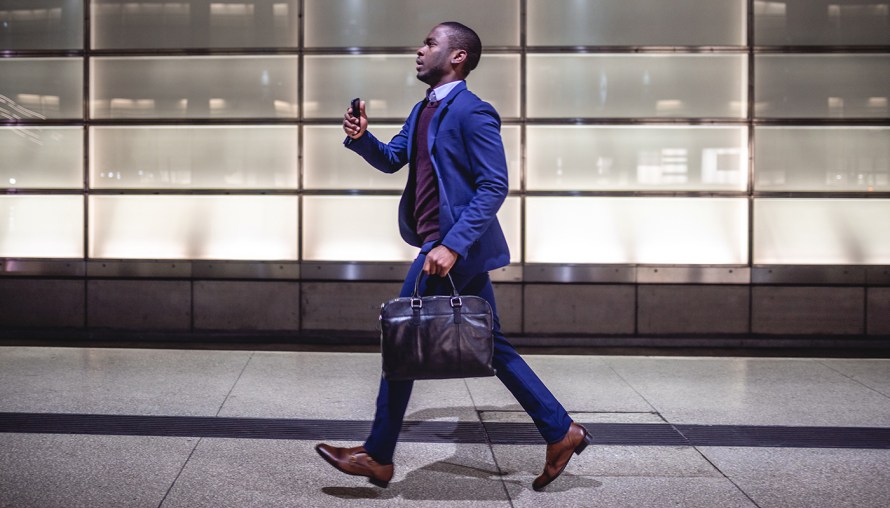 black man in a suit speed walking