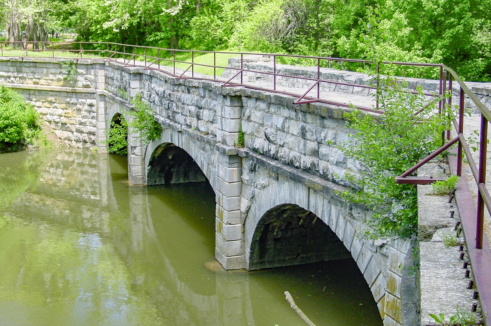 An aqueduct over still water. 