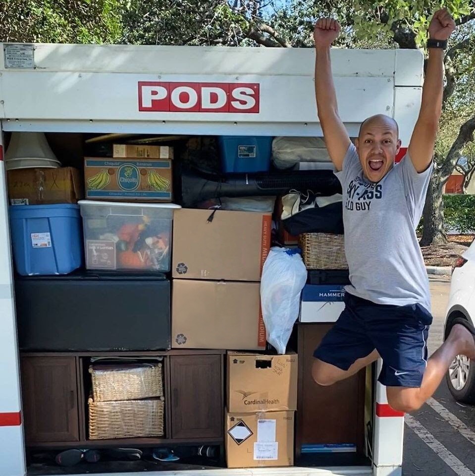 PODS customer, Louis S., jumps for joy in front of his expertly packed PODS moving container.
