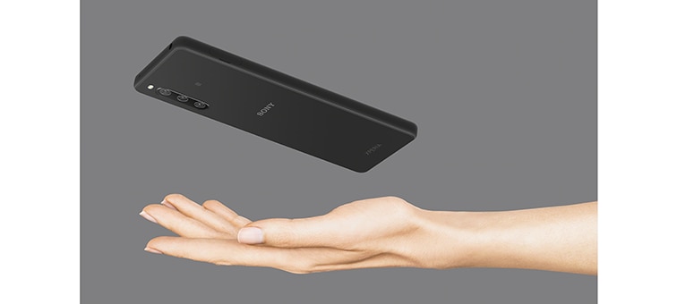 An Xperia 10 IV in black above an outstretched hand