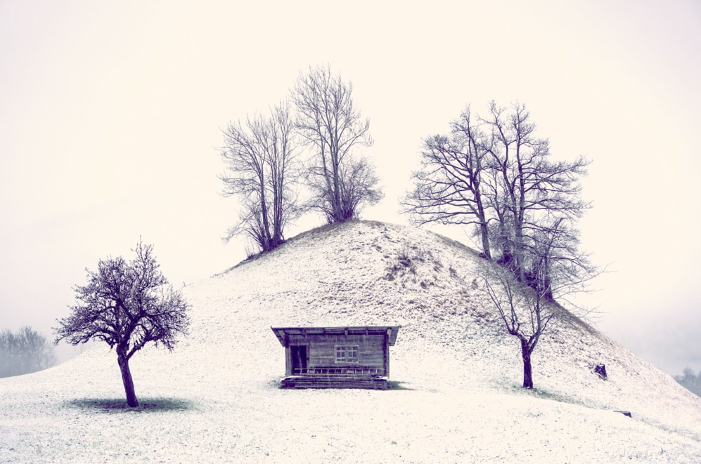 A small building on a snowy hill</p>
<p>Description automatically generated with low confidence