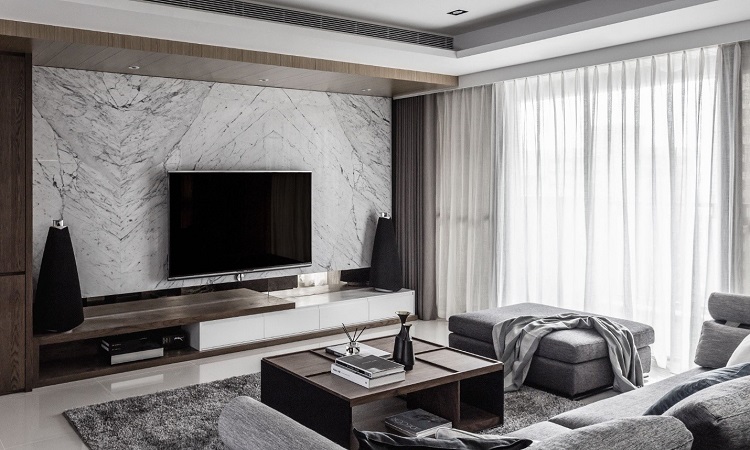 Đá marble với tông màu trắng và xám ốp sau khu vực để TV ăn khớp với tông màu tổng thể của phòng khách. 