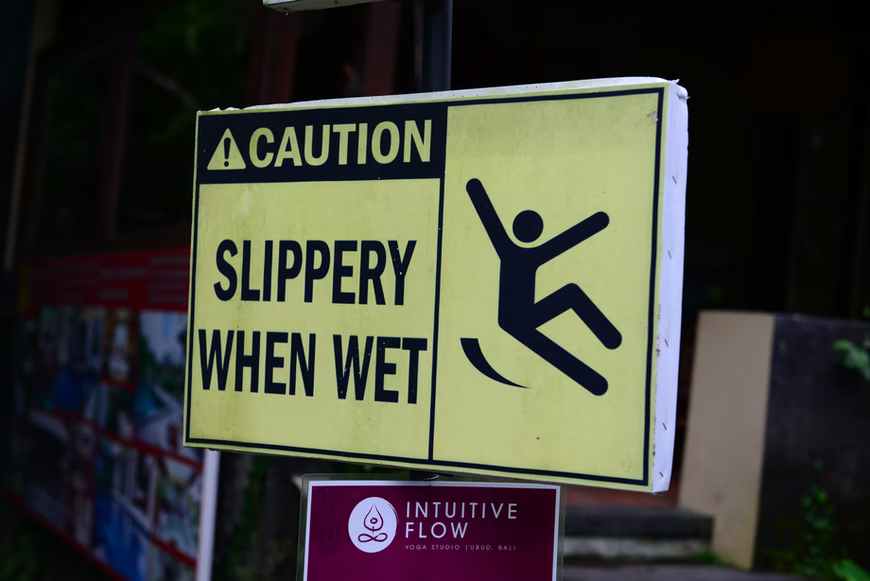  A sign indicating slipperiness when the surface is wet. Wet roads pose crashing risks for motorcycle riders, especially senior riders with slower reflexes.