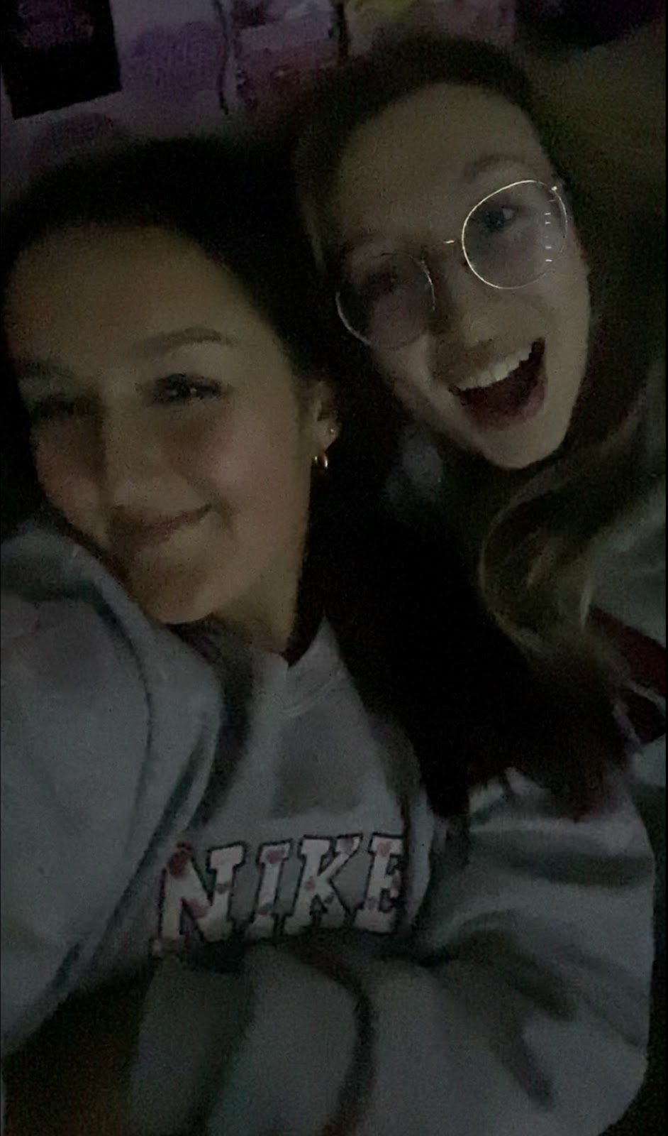 Chloe and roommate taking a selfie in a dark room