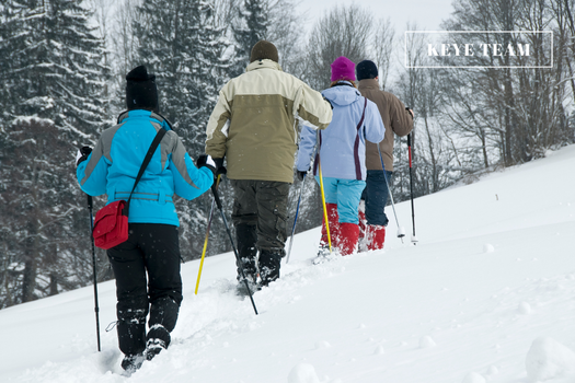 Image of a line of snowshoers walking up a hill in park city, utah.