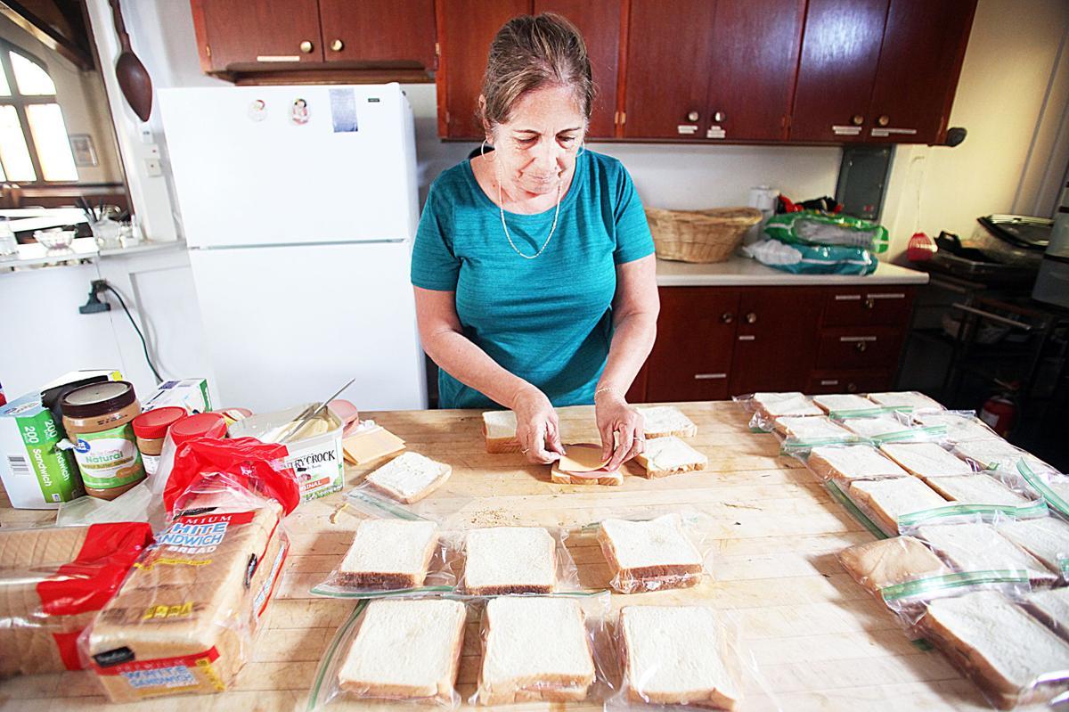 volunteers make sandwiches for refugees