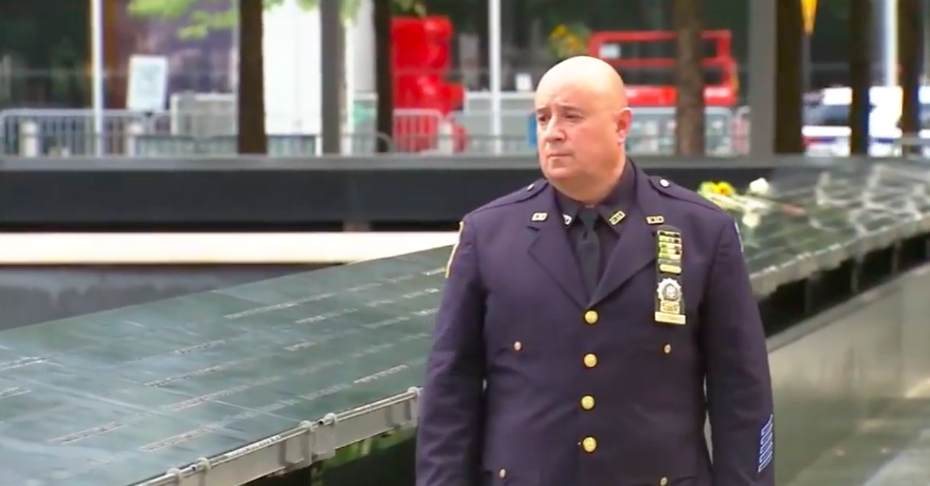 A police officer walks along the 9/11 memorial