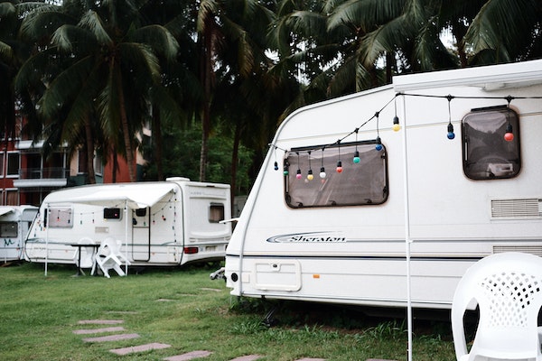 Multiple RV's parked on a field of grass.