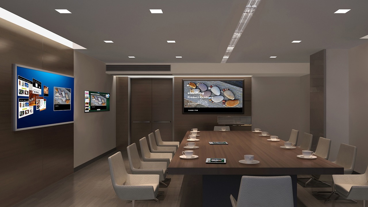 Commercial digital displays resembling a flat screen tv installed in a conference room. Source: MystiqueMuzik