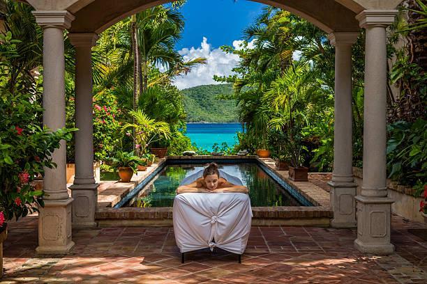 woman receiving a massage at a beautiful villa in Caribbean woman receiving a massage at a beautiful villa on St John, United States Virgin Islands resort spa stock pictures, royalty-free photos & images