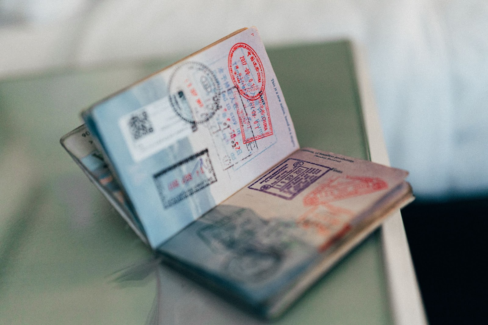 open passport showing many stamps from different countries