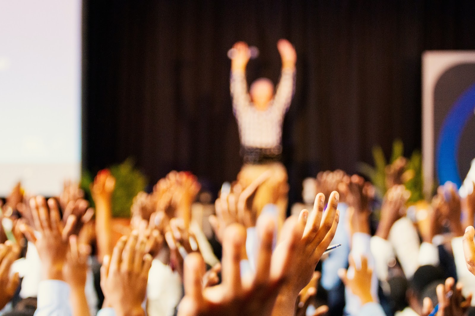 a group of people that are raising their hands as they participate in animation business networking for the animation industry