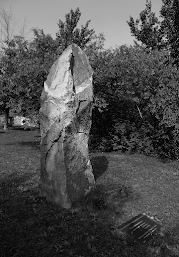 Fulda memorial stone, monolithic stone standing on its own. A plaque in the grass next to it describes the memorial and dedication.