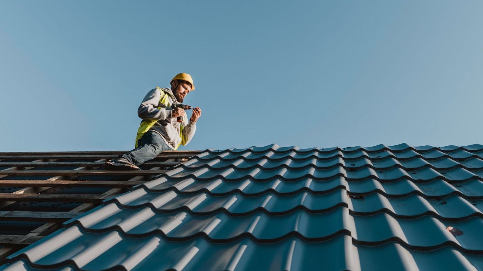 A man installing a metal roof