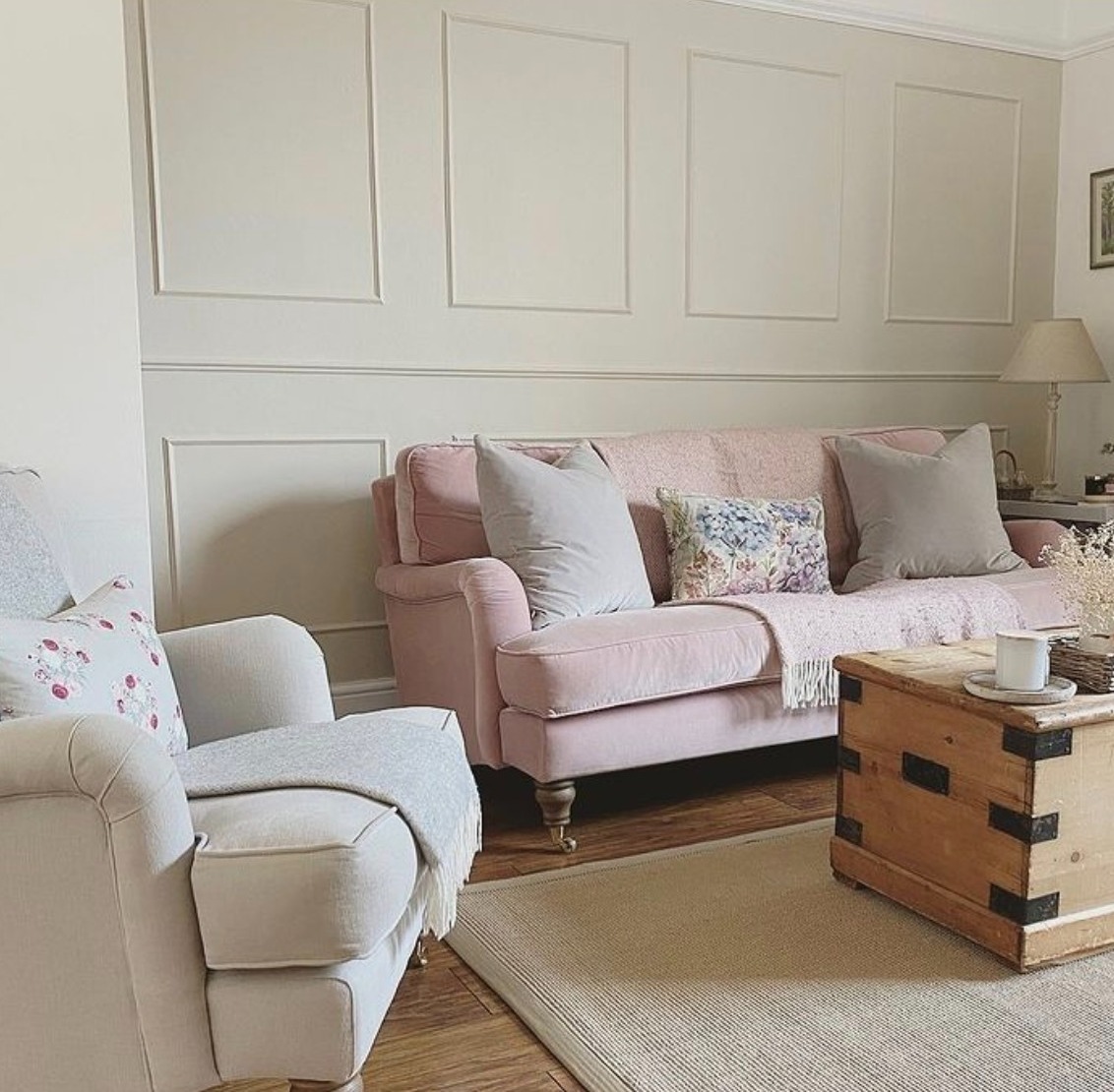 Living room with a pink sofa, and Shaded White by Farrow and Ball on the panelling