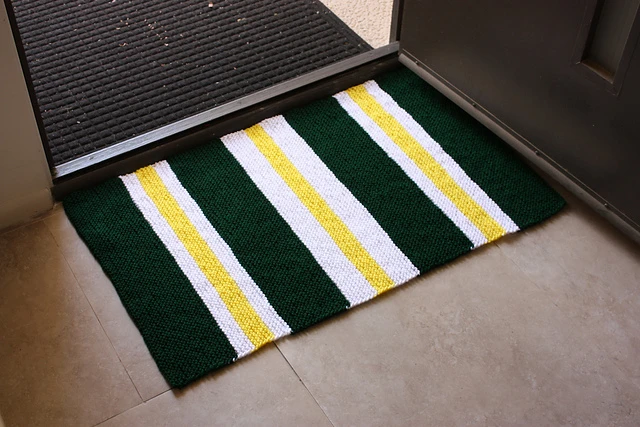 simple knit rug in three colors on floor