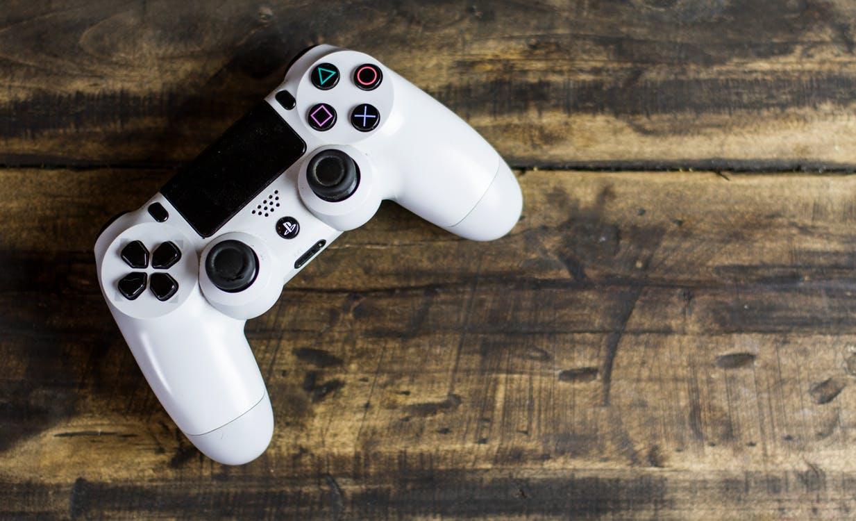 White Sony Ps4 Dualshock Placed on Table