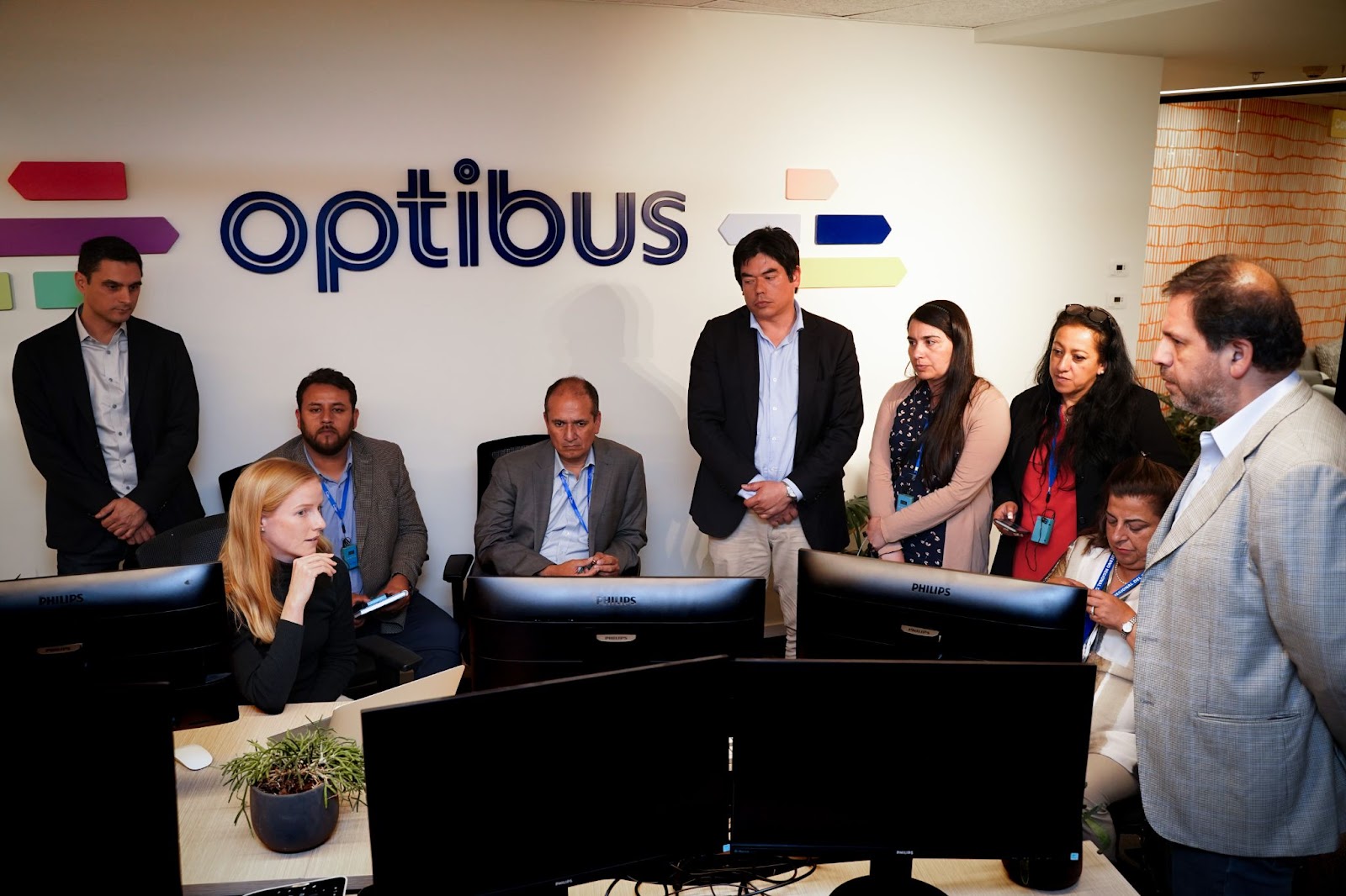 Optibus CEO and co-founder Amos Haggiag (standing, far left) and Catharina Michels, Presales Engineering Team Lead, EMEA (bottom left), demo the Optibus software for the BioBio delegation.