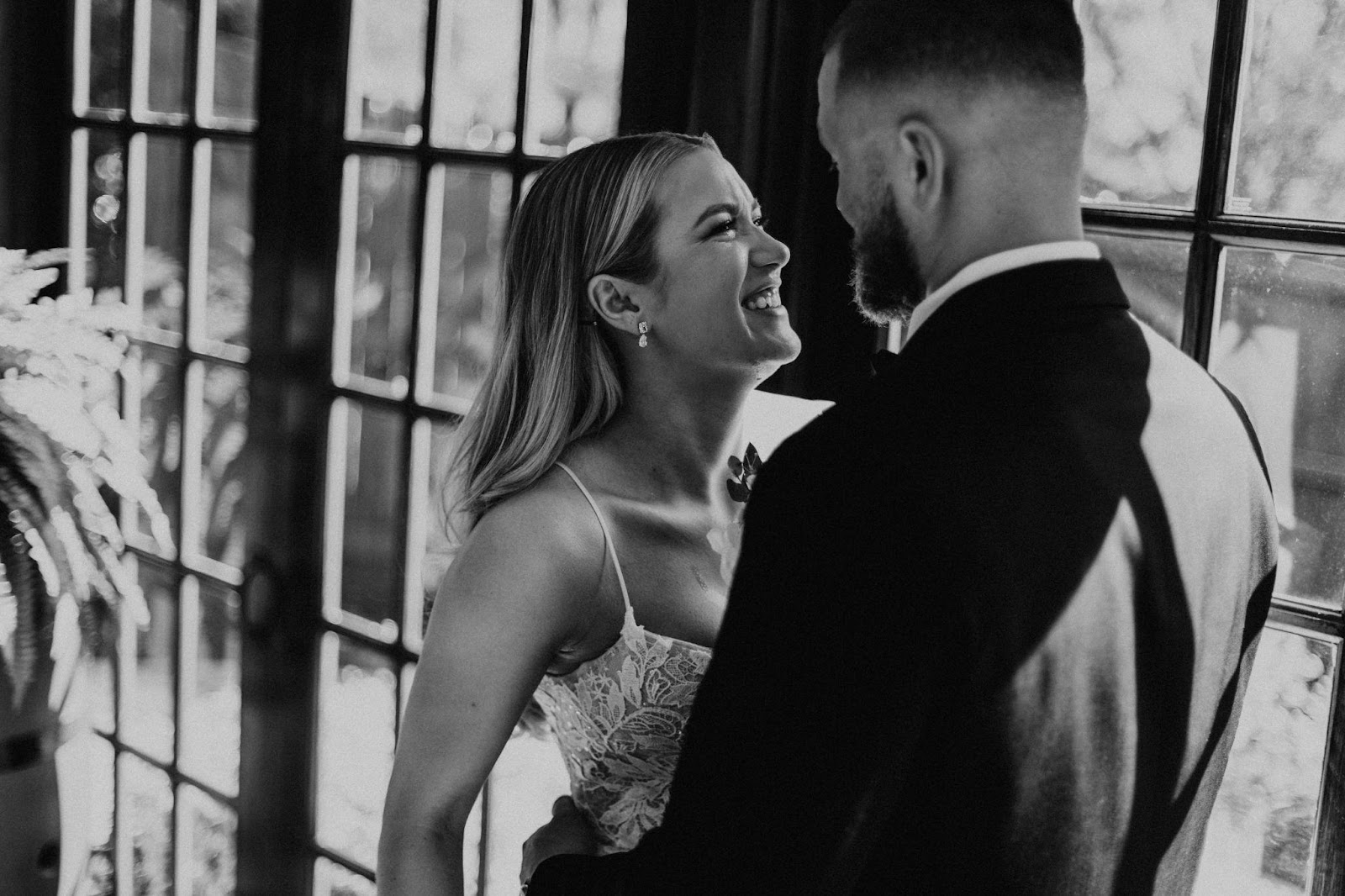 Couple laughing together in a photo taken before their reception.
