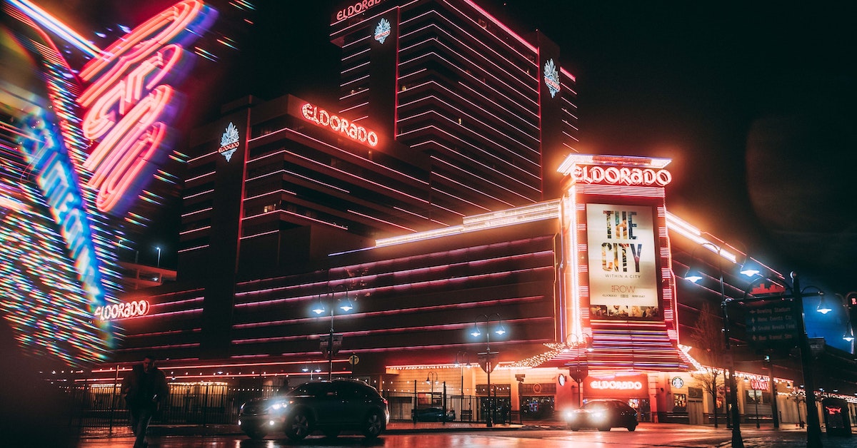 The El Dorado Hotel lit up in neon at night time.