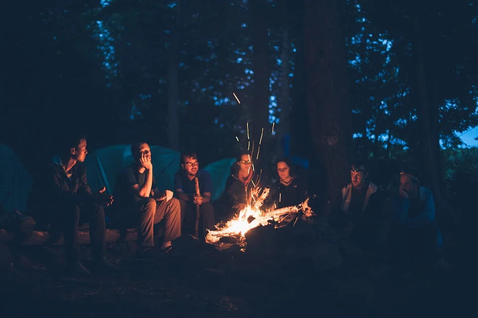 A group of people sitting around a campfire