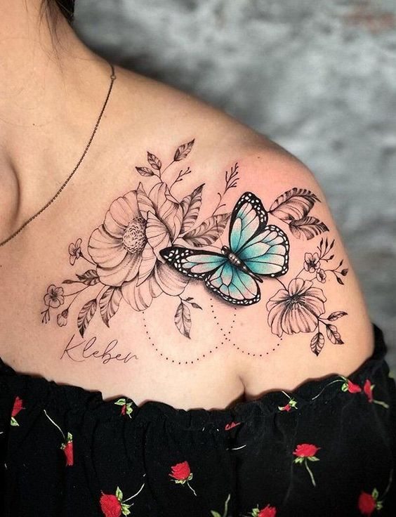 lady with a flower and butterfly shoulder tattoo