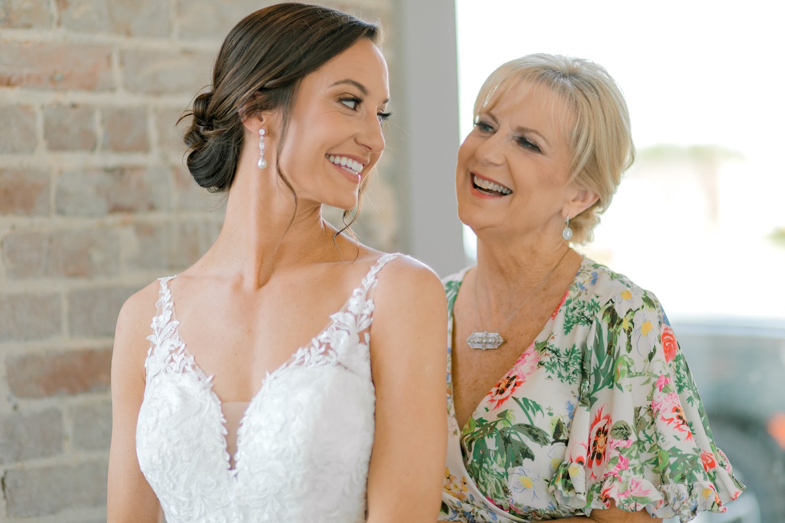 Bride's mom helping her get dressed