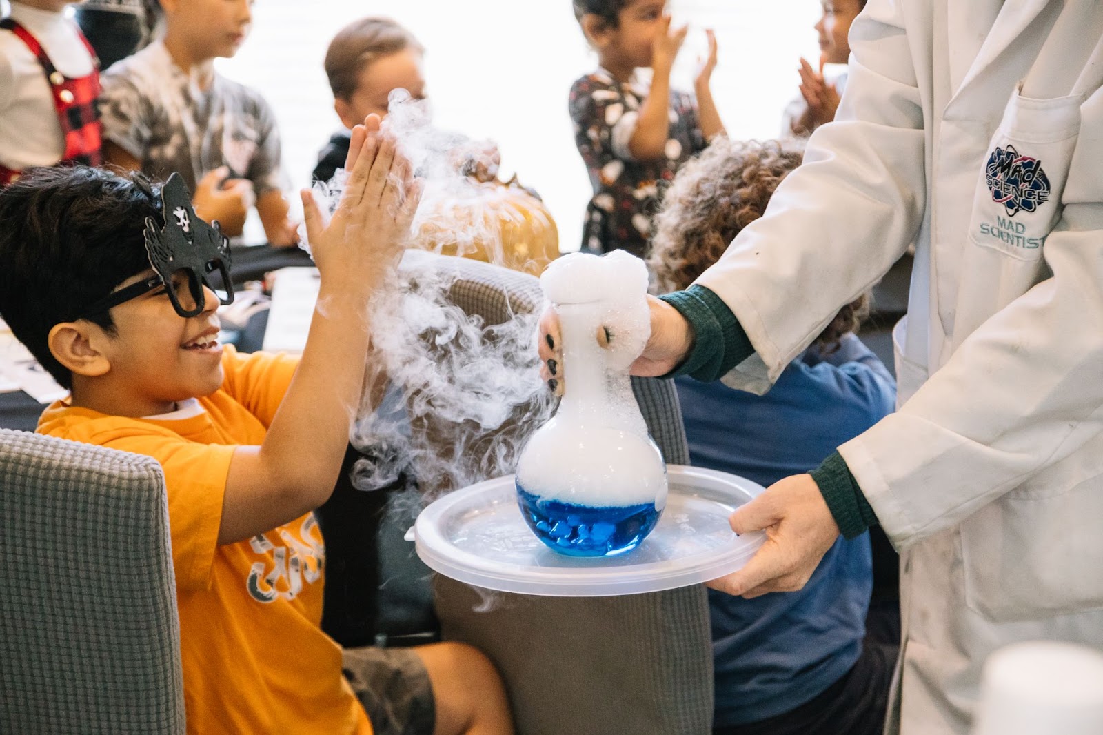 [Alt Text: A picture provided by The Everest Foundation of one of the children interacting with the Mad Scientists experiment at the Halloween event with Loving Hands Children’s Home.]