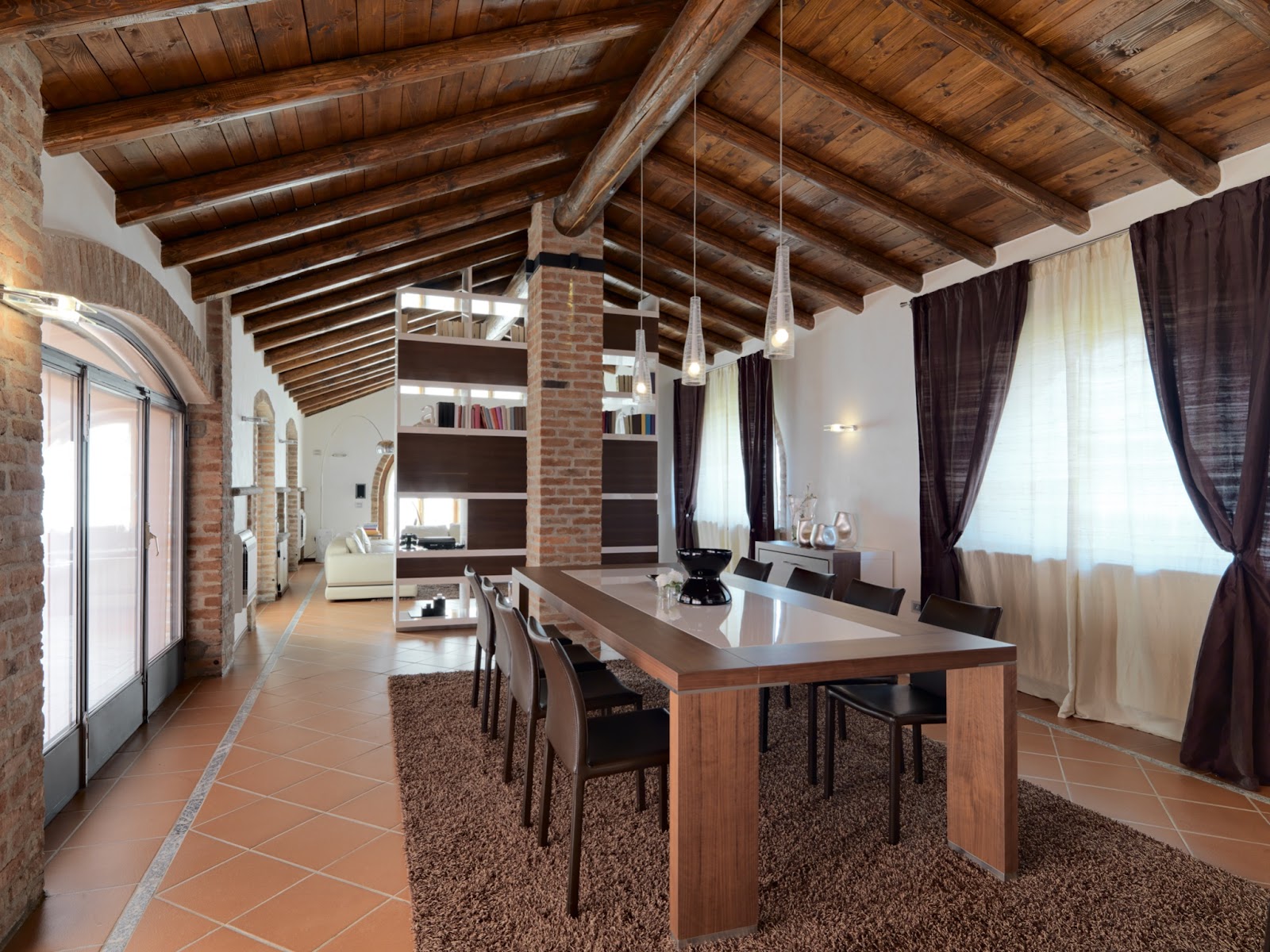 Terracotta tiled open plan dining room with brown accents
