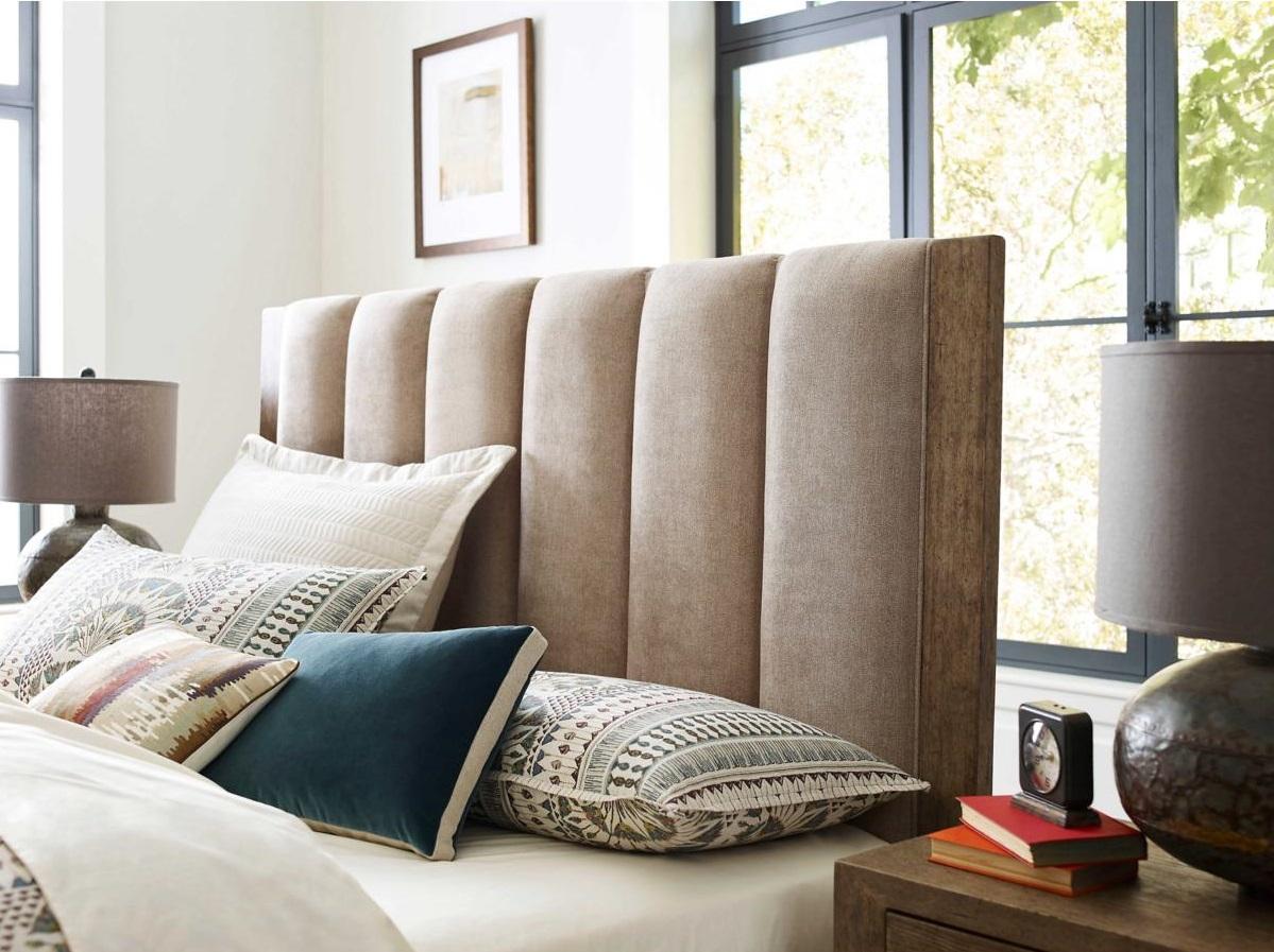 layered bedding with upholstered headboard