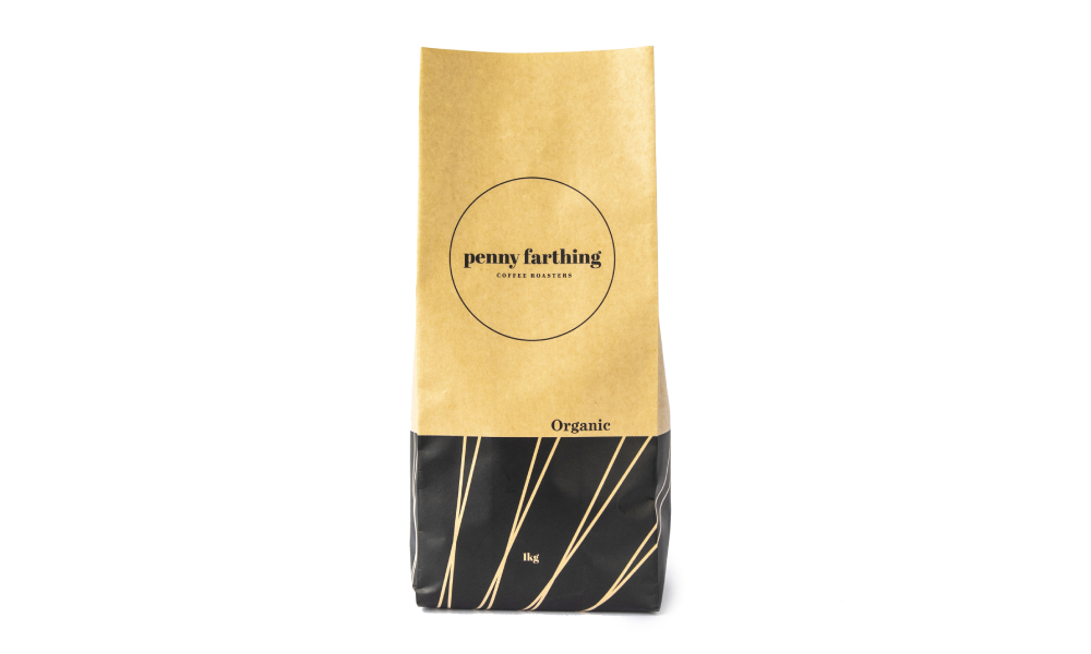 Gold and black Penny Farthing Coffee Roasters paper coffee pouch on white background