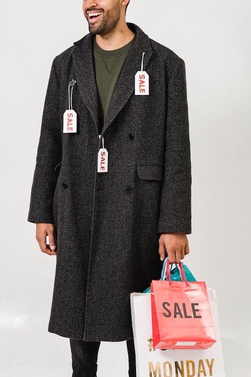 Free Man Wearing Gray Coat With Sale Tags Stock Photo