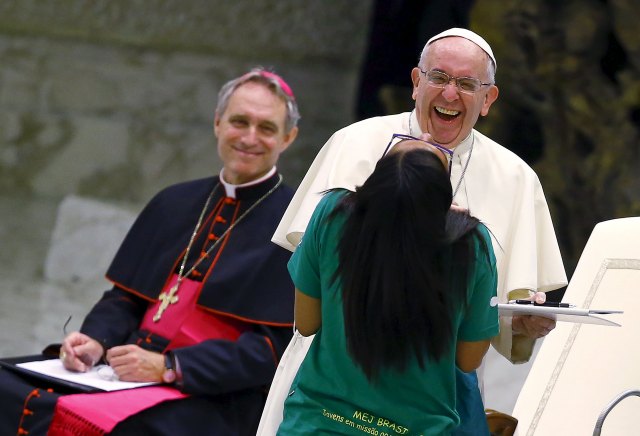 Pope Francis shares a laugh with a young woman at a special audience with a youth movement at the Vatican last summer. (CNS/Reuters)