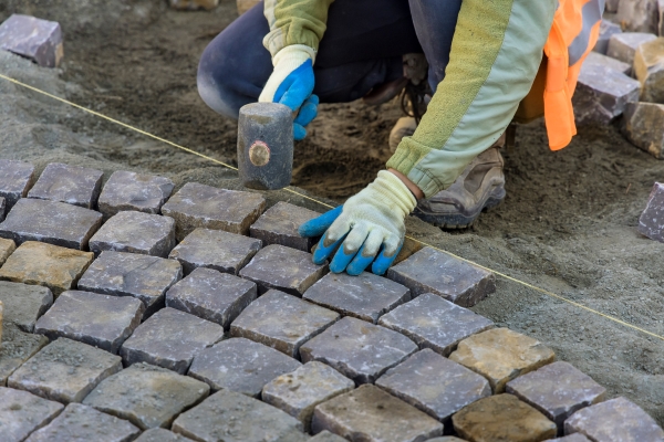 man laying bricks